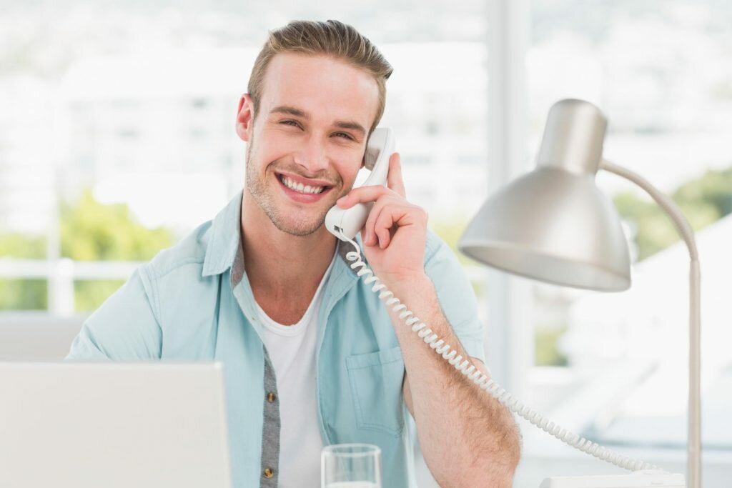 man smiling taking phone calls